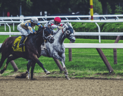 Jockeys riding horses at a major racetrack