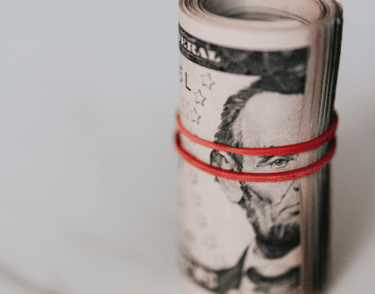 Dollar notes rolled up and secured with an elastic band